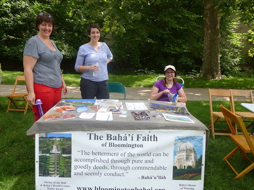 Bahá'í Faith members Sarah Enslow, Ruth Enslow and IU Alum Natalie Bantz represent the Bahá'í Faith of Bloomington center at Faith Fest. The Bahá'í Faith of Bloomington center offers weekly devotion to community members every Sunday at 10:30am.