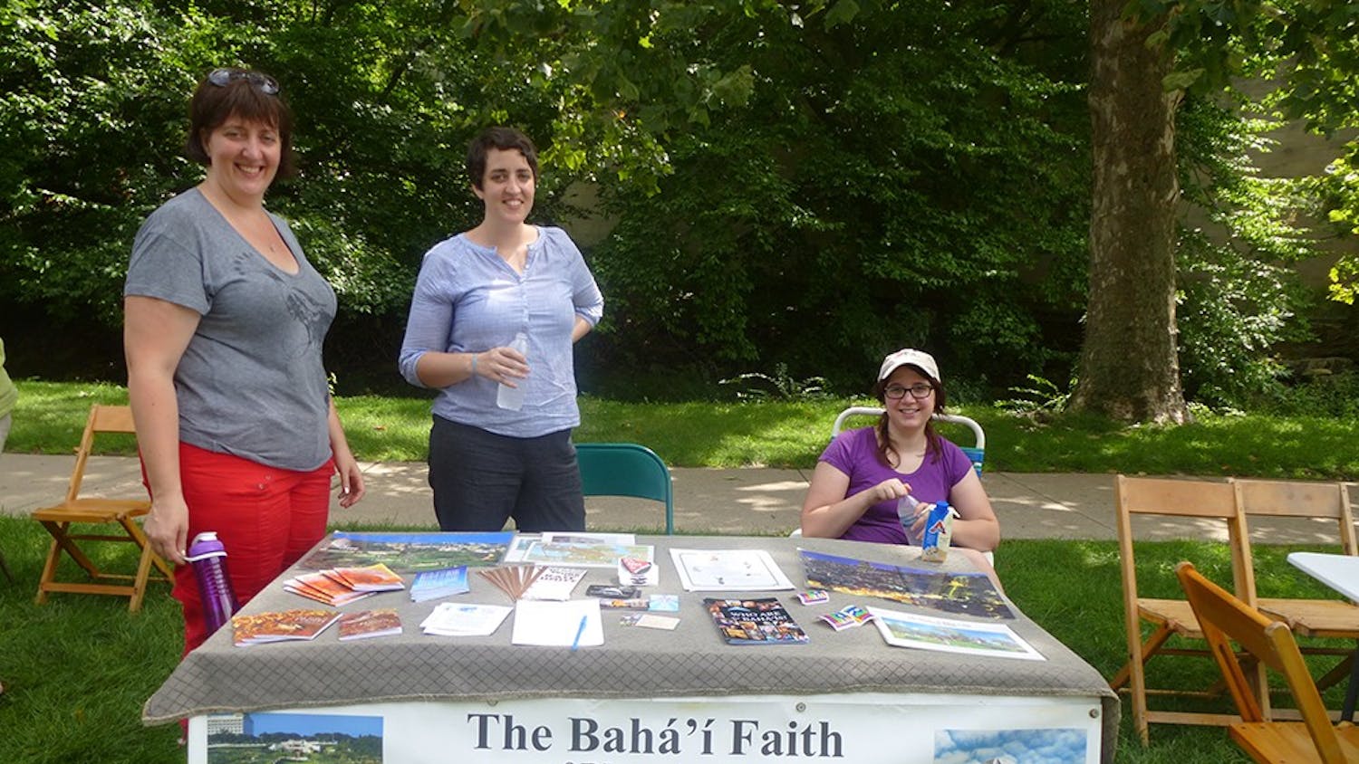 Bahá'í Faith members Sarah Enslow, Ruth Enslow and IU Alum Natalie Bantz represent the Bahá'í Faith of Bloomington center at Faith Fest. The Bahá'í Faith of Bloomington center offers weekly devotion to community members every Sunday at 10:30am.