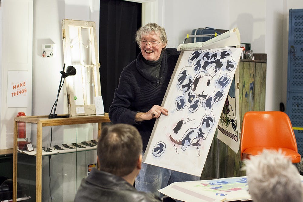 Printmaker Jim Simpson talks about his linocut prints at Blueline Media Productions on Thursday.  His work will be on display until Jan. 30th.