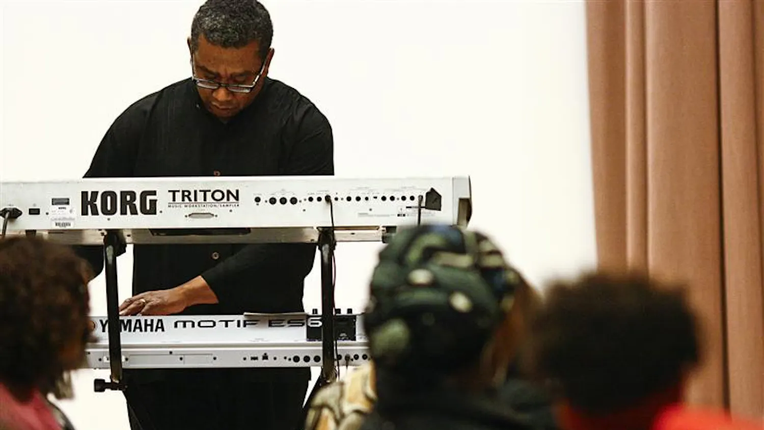 Top right: Keith McCutchen, director of the African American Choral Ensemble, plays the keyboard during the ceremony.