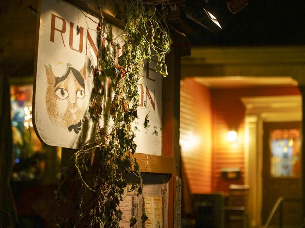 The exterior of the Runcible Spoon is decorated with foliage and lit by subtle lighting. The Runcible Spoon is located on East Sixth Street.