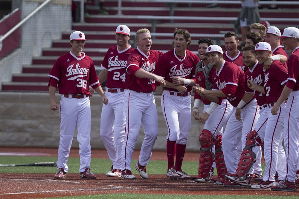 The IU baseball team wait for Tony Butler after his home run in the tenth to win the game against ISU on Sunday at Bart Kaufman field. The Hoosiers won 5-3. 