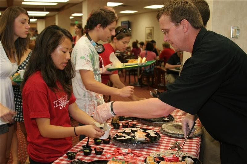 Dale Meyer, Sales and Marketing Manager for Okami, serves fresh-made sushi to students at the IMU Taste of the Union festival on Friday at the Indiana Memorial Union.  The event was filled with free food, music, bowling and more. 