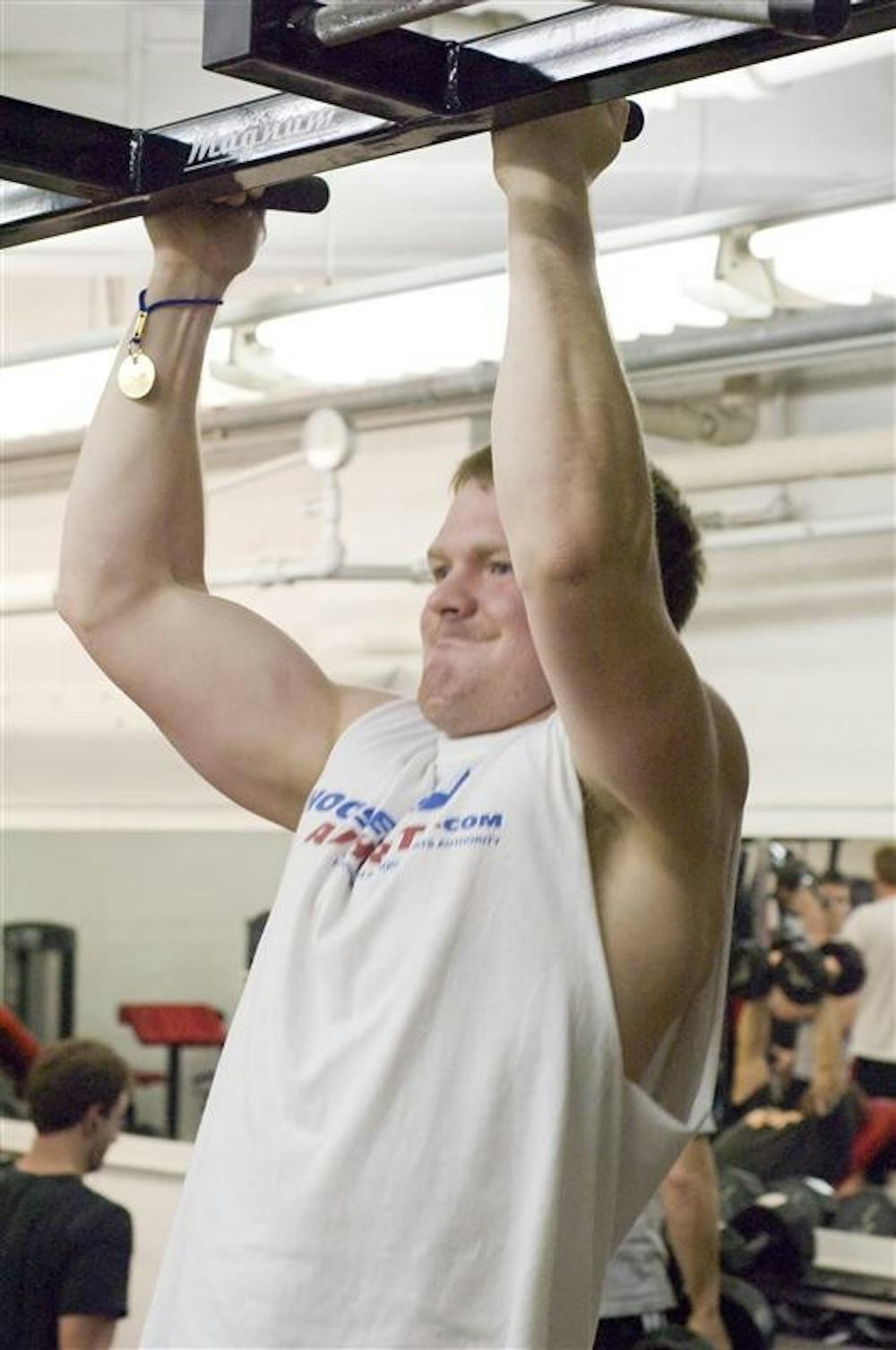 Sophomore Aaron Stobaugh does a pullup at the HPER weight room Wednesday evening. 