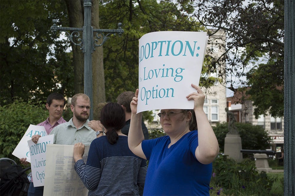 Crystal Laws holds a sign up outside of the Monroe County Courthouse on Tuesday. Laws was outside of the courthouse to protest the use of service grant money to support Planned Parenthood.