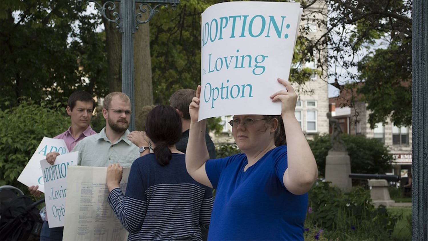 Crystal Laws holds a sign up outside of the Monroe County Courthouse on Tuesday. Laws was outside of the courthouse to protest the use of service grant money to support Planned Parenthood.