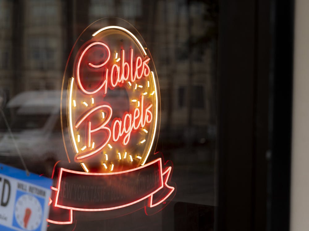 A Gables Bagels neon sign is seen through the door of the restaurant Sept. 5, 2022, on East Third Street. The store is owned by Ed Schwartzman, who also owns BuffaLouie’s in Bloomington.