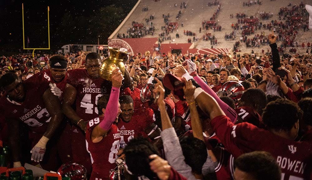 IU fans rush the field and players celebrate after defeating Michigan State 24-21 in overtime saturday night.