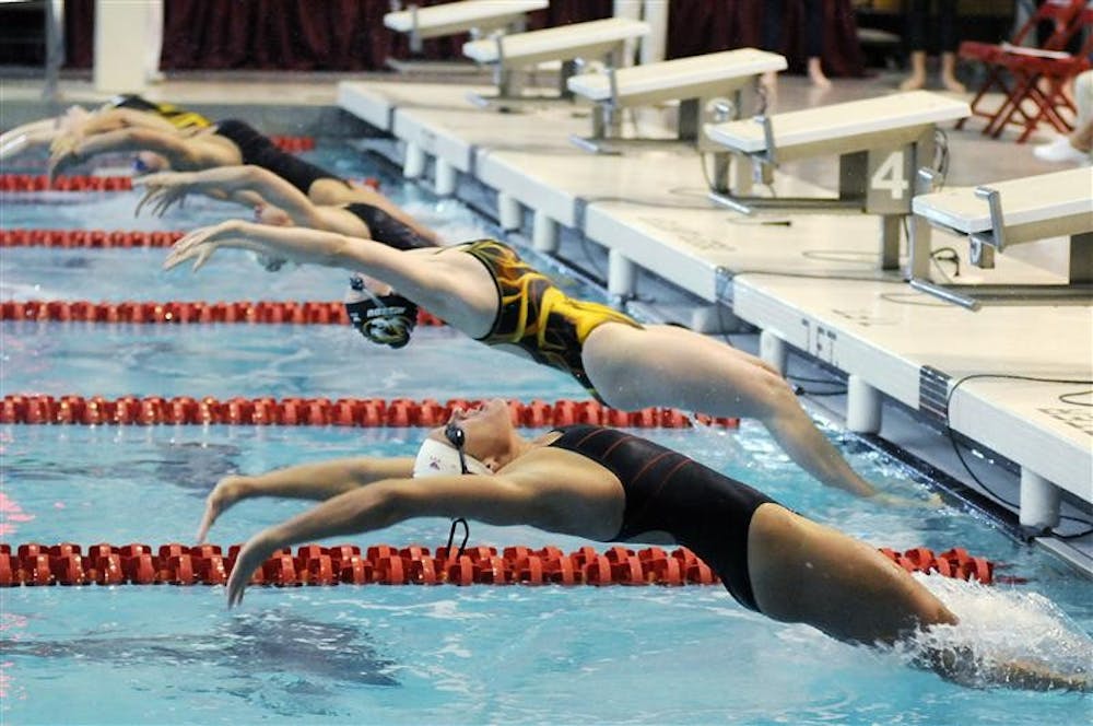 IU senior Kristin Cihoski, right, surges off the starting block for a 100-meter backstroke heat during a double dual meet against Ohio State and Missouri on Jan. 17, at the Counsilman-Billingsley Aquatic Center. Cihoski finished fifth in the finals.