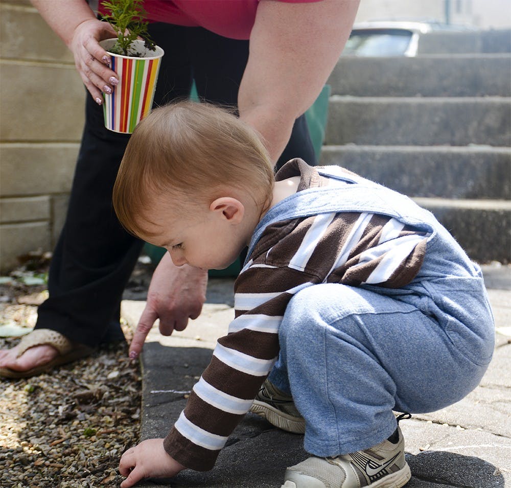 Paul Bowless learn to recognize earth for plants during an event named Generations Gardening Together on Sunday at the Monroe County Public Library. Participants from ages 4 and older plant flowers, vegetables, fruit and herbs together. 