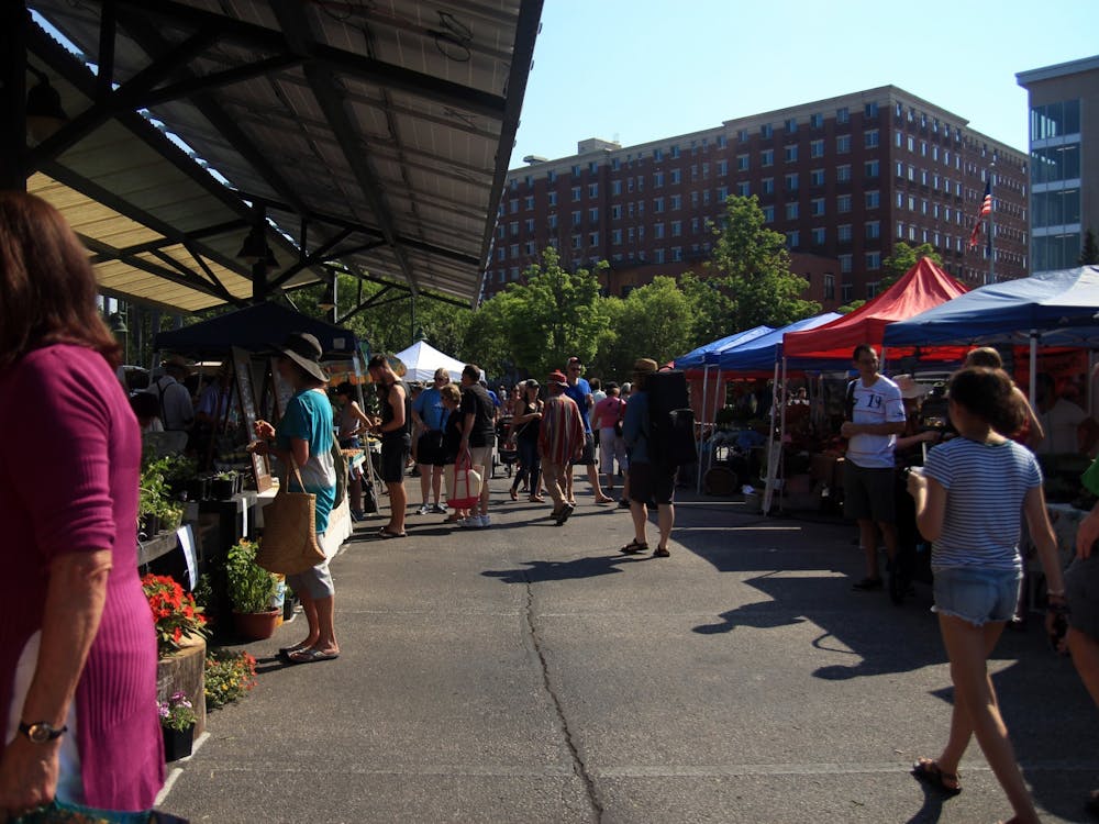 People walk through the aisles of vendors at the Bloomington Community Farmers&#x27; Market in 2018. The Tuesday Farmers’ Market and A Fair of the Arts both open for the first time this summer June 1 at Switchyard Park.