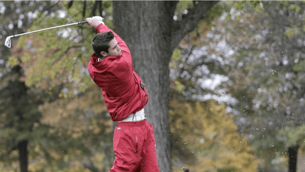 Then-freshman Max Kollin tracks the flight of his tee shot on the par-3 eighth hole at the Delaware Country Club during the Earl Yestingsmeier Invitational on Nov. 15, 2012.