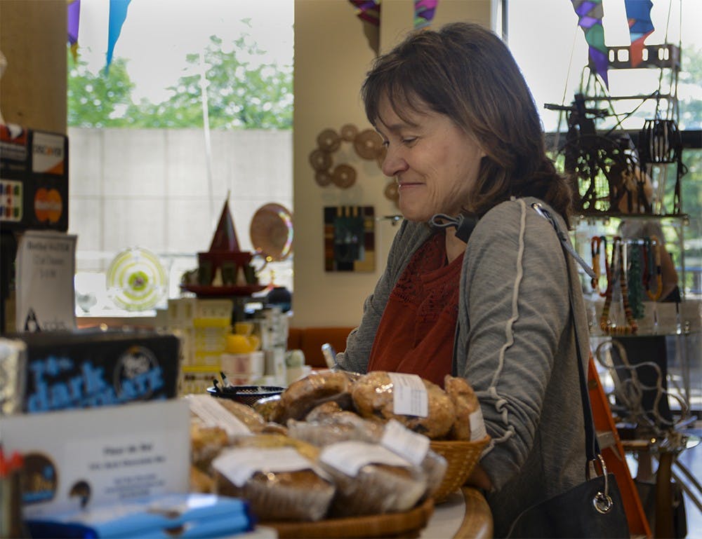 Marthe MacLeish, director of undergraduate studies of studio art department, orders coffee Friday Morning at the Eskenazi Museum of Art, Angles Cafe Gift Shop. MacLeish said she love to meet faculties and have holiday shopping in Angles. 