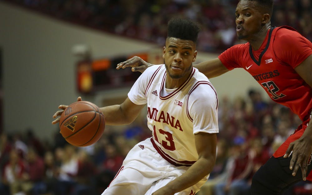 Sophomore forward Juwan Morgan pushes past sophomore forward Ibrahima Diallo of Rutgers University for a layup.  The Hoosiers beat Scarlet Knights 76-57 Sunday.    
