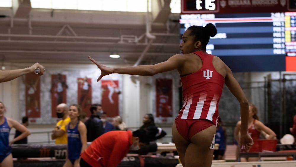 Alyssa Robinson receives the baton pass on Jan. 22, 2022, during the Women&#x27;s 4 x 400 relay at the Gladstein Invitational at the Harry Gladstein Fieldhouse. Robinson took home first place in the 200-meter dash at the Raleigh Relays over the weekend.
