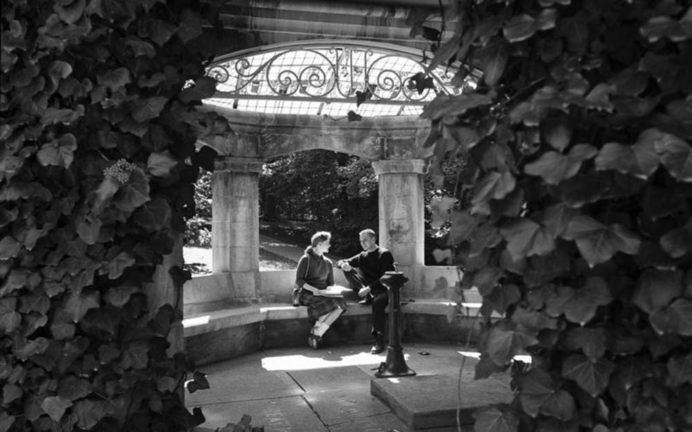 Students sit in the Rose Well House in September 1958. The tradition of kissing under the structure was, at that time, about 50 years old, and this photo appears in October 1959.&nbsp;