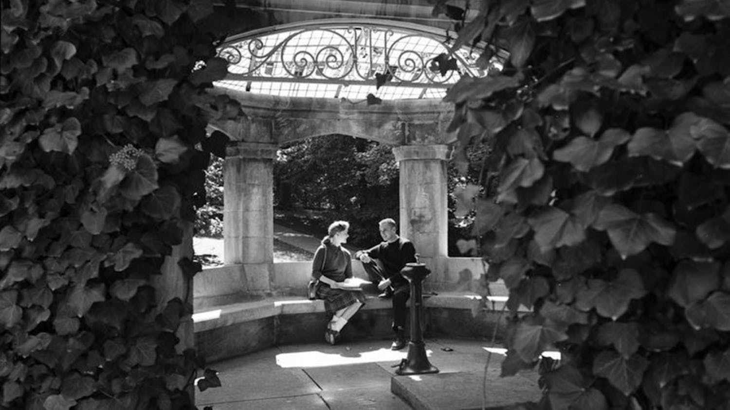 Students sit in the Rose Well House in September 1958. The tradition of kissing under the structure was, at that time, about 50 years old, and this photo appears in October 1959.&nbsp;