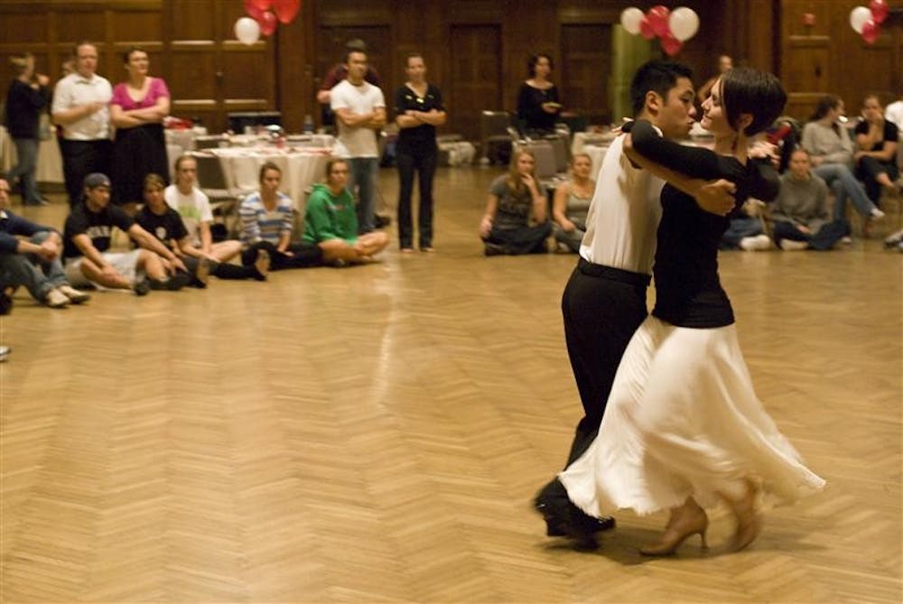 IU junior and captain of the Ballroom Dancing Team Steve Torres and IU senior and Ballroom Dancing Club vice president Casey Green exhibit the tango to newcomers during the IU Ballroom Dance Club call-out meeting on Sunday night in Alumni Hall in the Indiana Memorial Union. The club meets every Thursday night from 8:30-10:30 in HPER room 171.