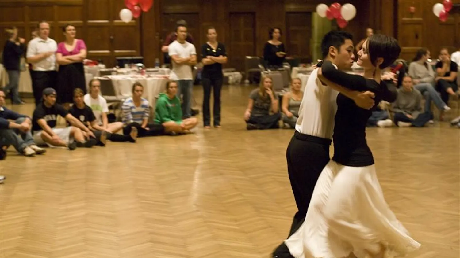 IU junior and captain of the Ballroom Dancing Team Steve Torres and IU senior and Ballroom Dancing Club vice president Casey Green exhibit the tango to newcomers during the IU Ballroom Dance Club call-out meeting on Sunday night in Alumni Hall in the Indiana Memorial Union. The club meets every Thursday night from 8:30-10:30 in HPER room 171.