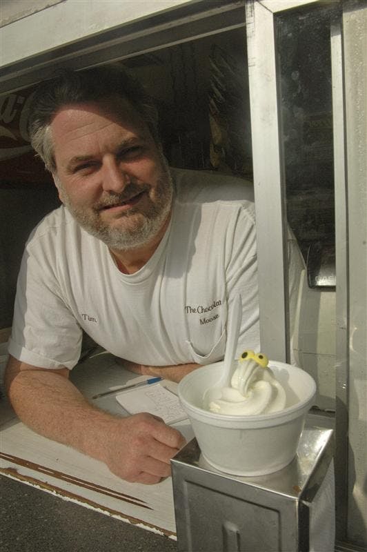Chocolate Moose owner Tim May stands next to a soft-serve creation in his shop at 401 S. Walnut St.  