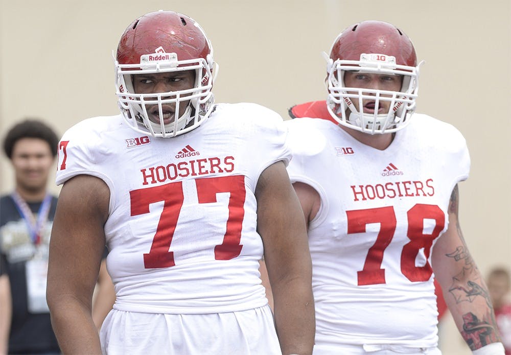 Junior Dimitric Camiel and senior Jason Spriggs watch offensive linemen drills before IU's spring game Saturday at Memorial Stadium.