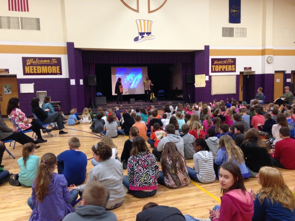 Students watch Kim Harris's and Reggie Harris's performance Monday at Needmore Elementary School, Bedford. 