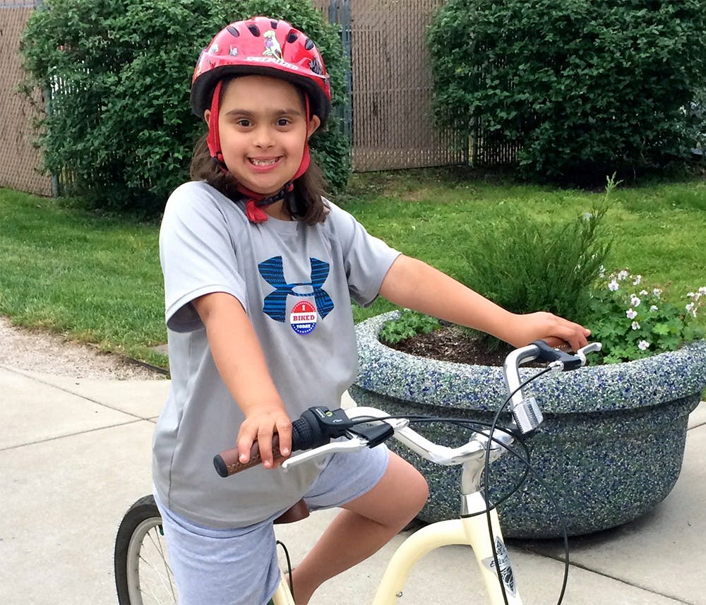 Ava Butske sits on her bike at Bloomingfood's annual "Bike to Work Day Block Party" Saturday at the Near West Side Bloomingfoods location. Ava learned how to ride at an iCan Bike camp in Greenwood, Ind.