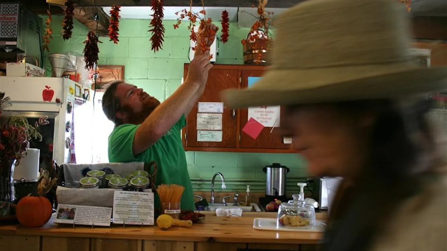 Musgrave Orchard and Cider Mill co-owner and IU alumnus Andy Hamilton handles some of his store products on Sunday.