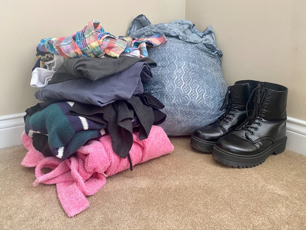 A donation pile of clothes is pictured May 25, 2023, against a wall in Natalie’s room. Getting rid of old items can benefit one mentally.