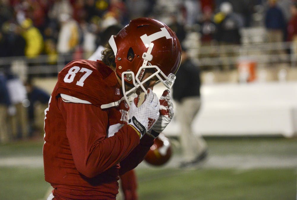 Wide receiver Mitchell Paige walks off the field after missing the final pass in double overtime against Michigan on Saturday at Memorial Stadium. The Hoosiers lost, 41-48.