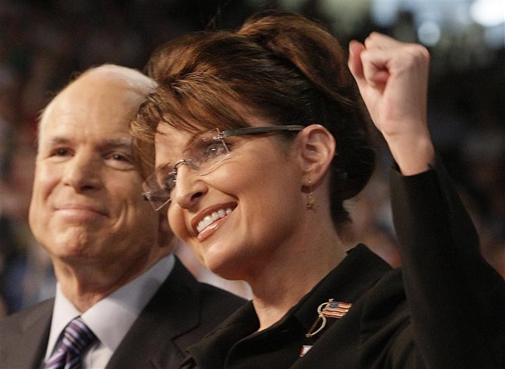 Presumptive Republican presidential nominee Sen. John McCain, R-Ariz., left, smiles as his Vice Presidential running mate, Alaska Gov. Sarah Palin, pumps her fist as she is introduced to supporters at a campaign rally on Friday in Dayton, Ohio.