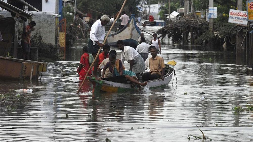 The Associated Press
Villagers use a boat to move around on Wednesday in the flood devastated district of Krishna, 156 miles from Hyderabad, India.