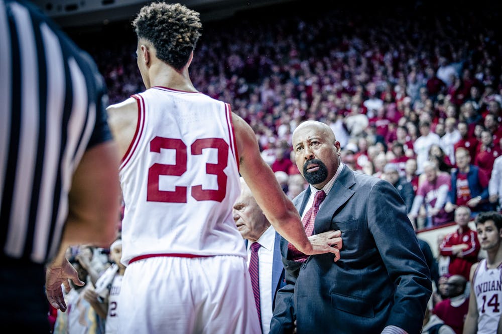 <p>Senior forward Trayce Jackson-Davis separates head coach Mike Woodson from a referee Feb. 4, 2023, at Simon Skjodt Assembly Hall in Bloomington. Jackson-Davis passed Woodson on Indiana&#x27;s all-time scoring list Saturday.</p>