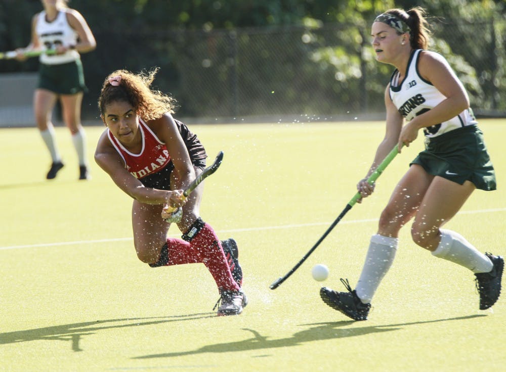 <p>Junior midfielder Andi Jackson hits the ball past Michigan State forward Kelsey Keener on Oct. 5 at the IU Field Hockey Complex. IU won against Michigan State 1--0, and the teams will face off again on Friday in the Big Ten Tournament.</p>