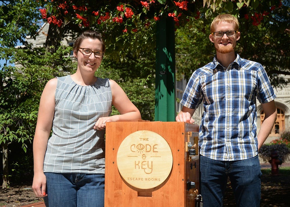 <p>Founders Kate and Alex Burch pose with a puzzle box they made. The Code and Key Escape Rooms is the new escape room located in Fountain Square Mall.</p>