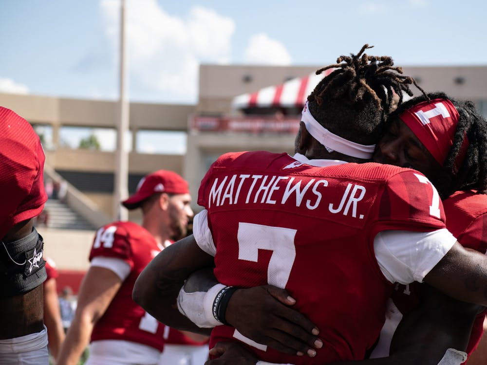 Graduate wide receiver D.J. Matthews Jr. and redshirt sophomore line backer Myles Jackson embrace after Indiana&#x27;s win against Western Kentucky Universty on Sept. 17, 2022, at Memorial Stadium. Indiana defeated Western Kentucky University 33-30 and improved to a 3-0 record.