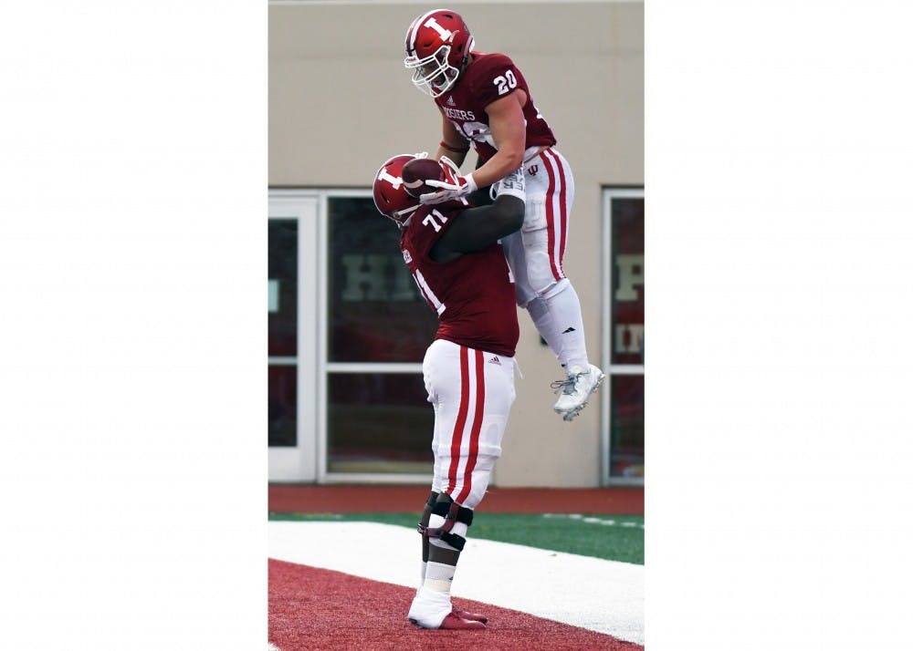 Freshman running back Cole Gest celebrates with freshman offensive lineman Delroy Baker after scoring a touchdown against Rutgers on Saturday afternoon at Memorial Stadium. Gest had 104 rushing yards in IU's 41-0 win against Rutgers.
