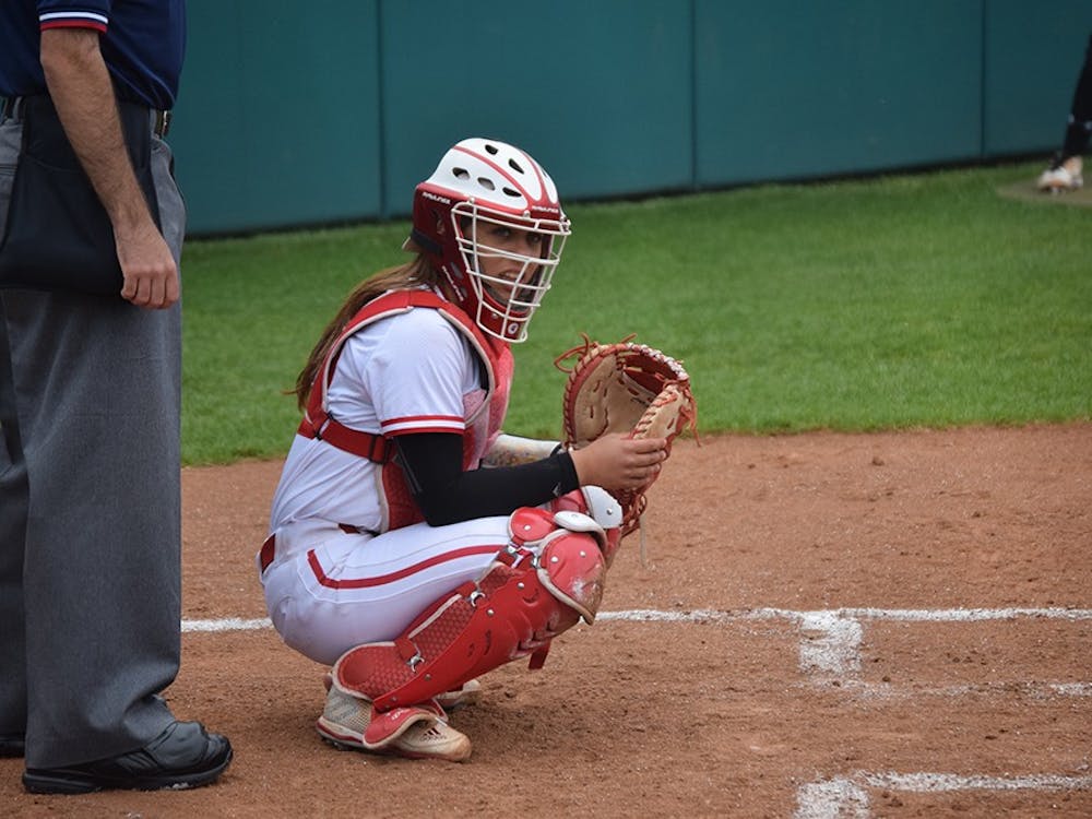Freshman catcher Bella Norton looks to the dugout to see what pitch to call on Friday, April 21, 2017. The Hoosiers defeated the Terrapins in all three games in Bloomington.