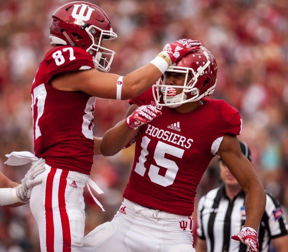 Senior wide receiver Mitchell Paige celebrates with sophomore wide receiver Nick Westbrook on the field at Memorial Stadium during IU's win over Ball State. The pair helped IU to a win over No. 17 Michigan State on Oct. 1.&nbsp;