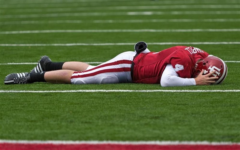 IU sophomore quarterback Ben Chappell lies face down on the field after being injuried during IU's 55-20 loss to Wisconsin on Saturday at Memorial Stadium. Chappell did not return to the game after the play.