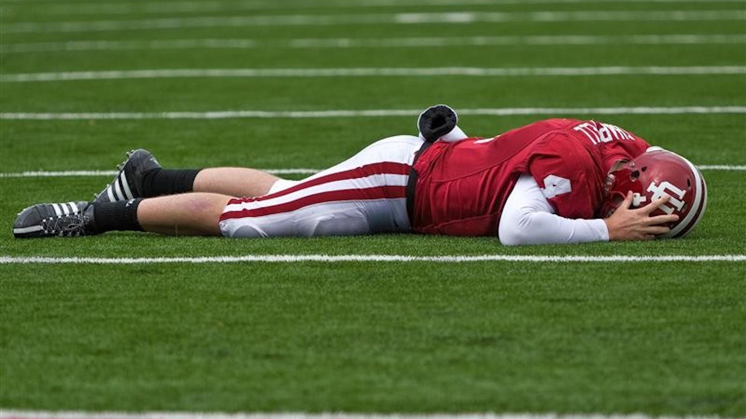 IU sophomore quarterback Ben Chappell lies face down on the field after being injuried during IU's 55-20 loss to Wisconsin on Saturday at Memorial Stadium. Chappell did not return to the game after the play.