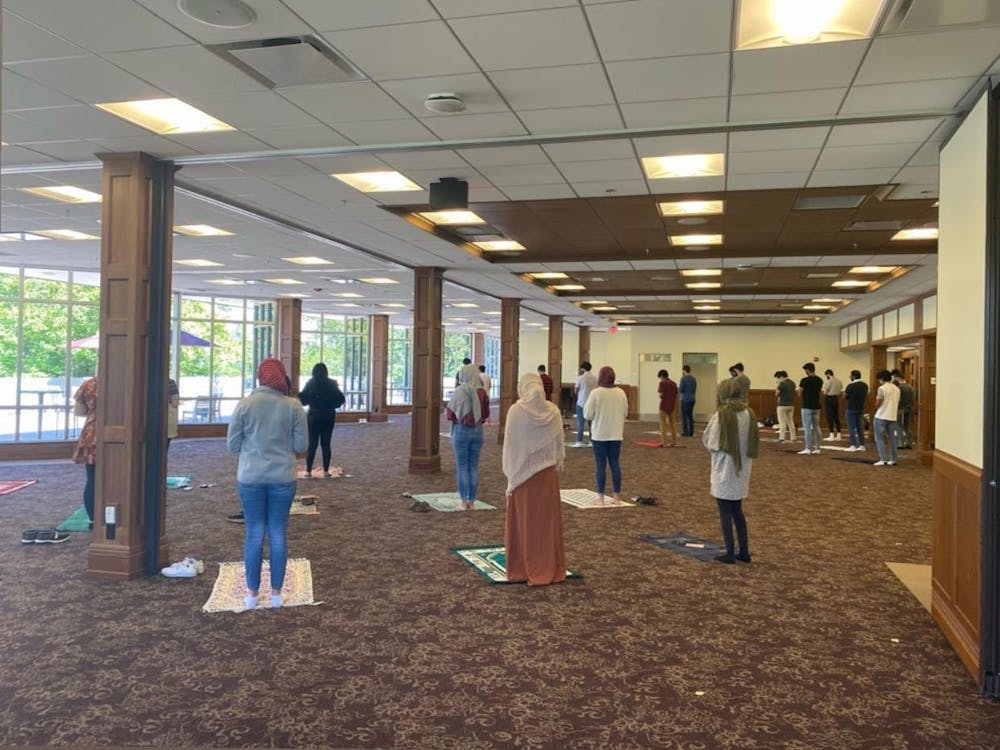 Members of the IU Muslim Student Association pray in a room in the Indiana Memorial Union. The MSA currently uses the Solarium in the IMU for weekly prayer.