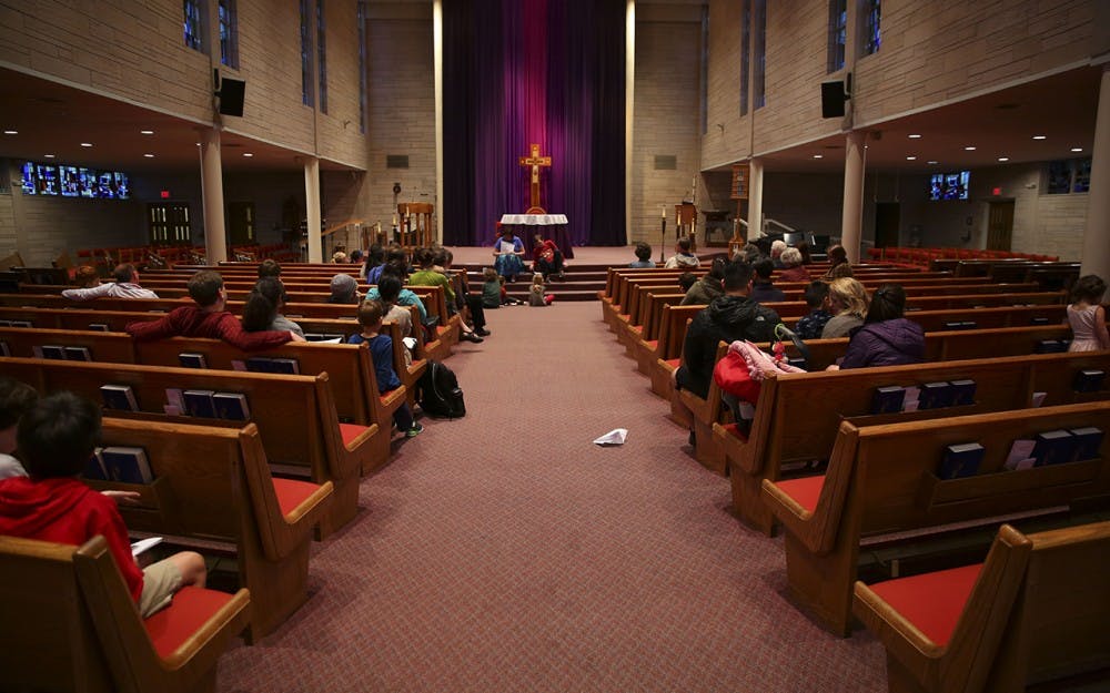 Members of the St. Paul's on 17th St. sit during 'story hour' before the church's first anual Carnevale feast.  The Church began this tradition in 2017 as a celebration of Carnevale.  