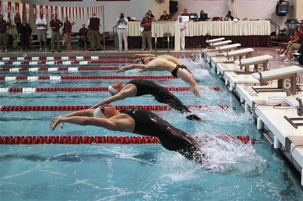 Swimmers launch off the starting block during a backstroke heat on Saturday at the Counsilman-Billingsley Aquatic Center. IU defeated Ohio State, 163-137, and Missouri, 239-61.