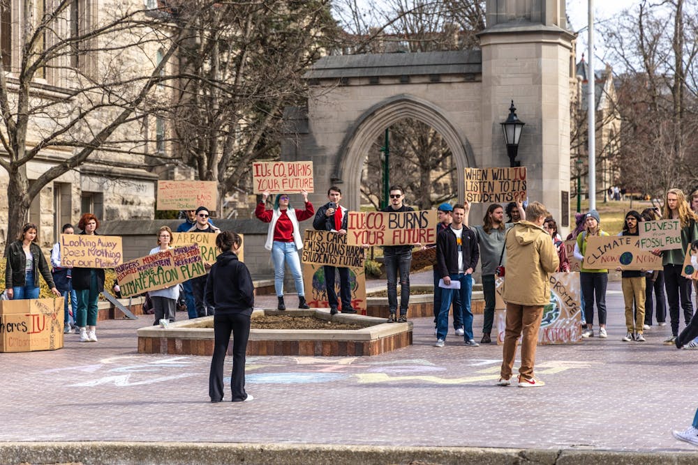 <p>A crowd listens to a speaker during Students for a New Green World&#x27;s protest for climate action March 4, 2022, in front of Sample Gates. IU President Pamela Whitten established the Climate Action Planning Committee in April 2022 with the primary purpose of developing ways to reduce greenhouse gas emissions on campus.</p>