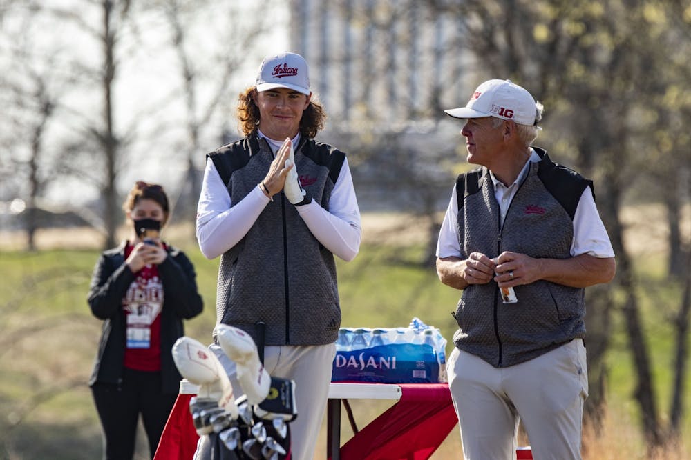 <p>Then-freshman Clay Merchent talks to head coach Mike Mayer on April 4, 2021, at the Pfau Course. Indiana competed in six events in the fall and eight events in the spring.</p>