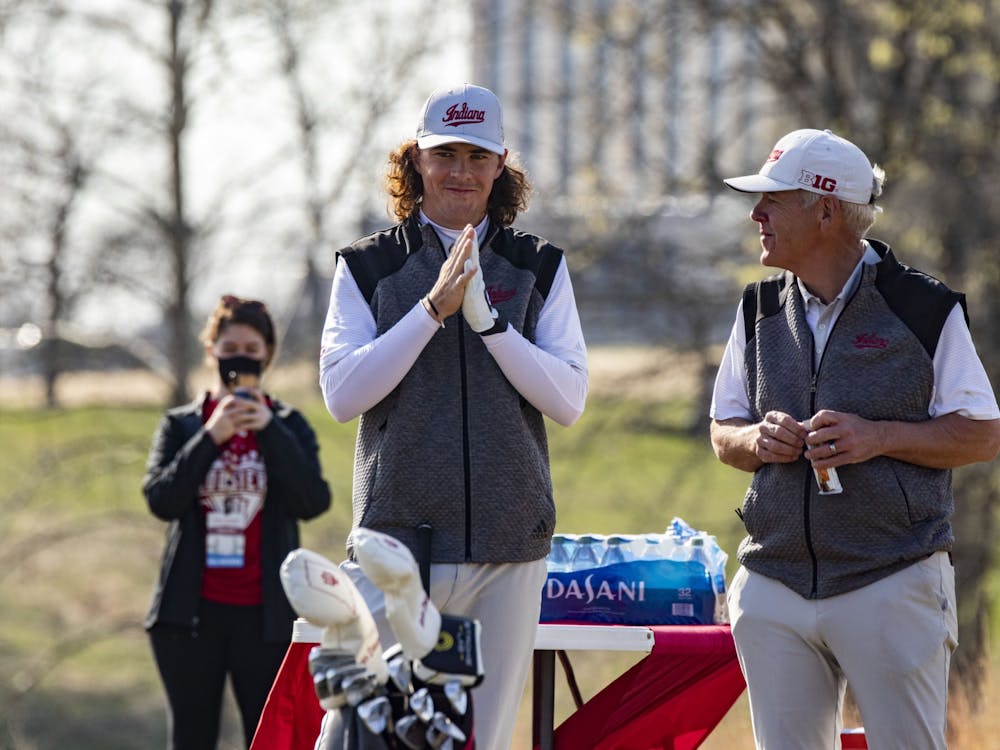 Then-freshman Clay Merchent talks to head coach Mike Mayer on April 4, 2021, at the Pfau Course. Indiana competed in six events in the fall and eight events in the spring.