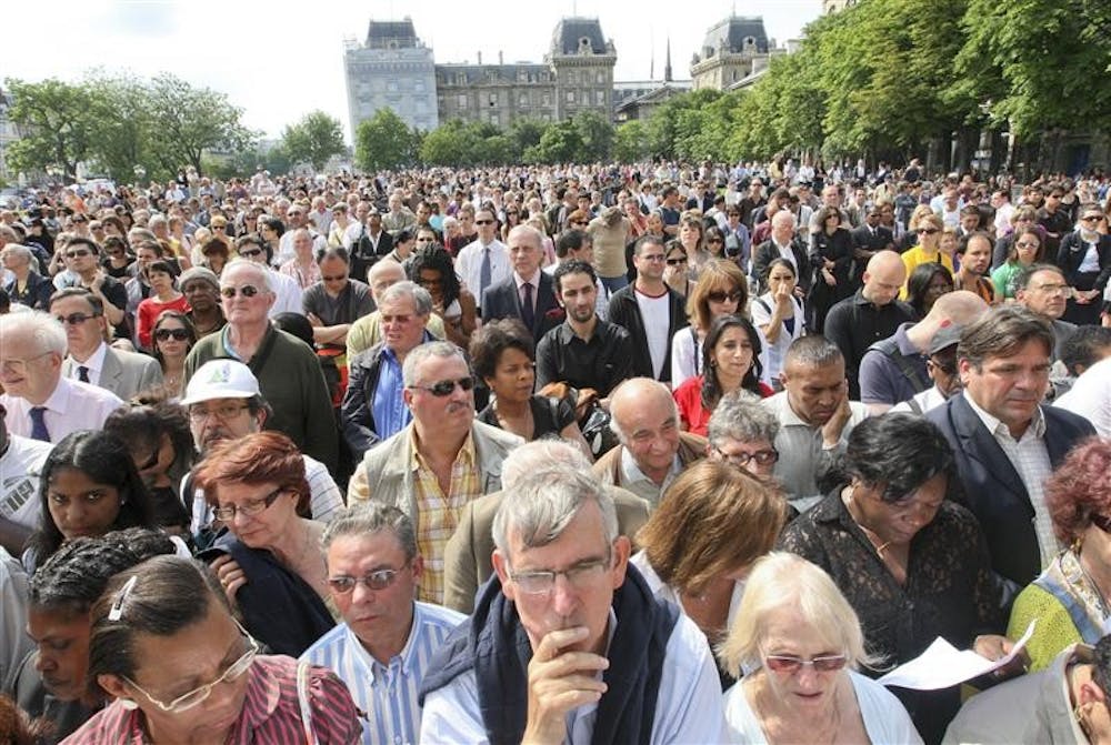 People stand outside the Notre Dame cathedral where an ecumenical church service for relatives and families of the passengers of Air France's Flight 447,  which vanished Sunday over the Atlantic Ocean on Wednesday in Paris. The reason for the crash remains unclear, with fierce thunderstorms, lightning or a catastrophic combination of causes as possible theories.