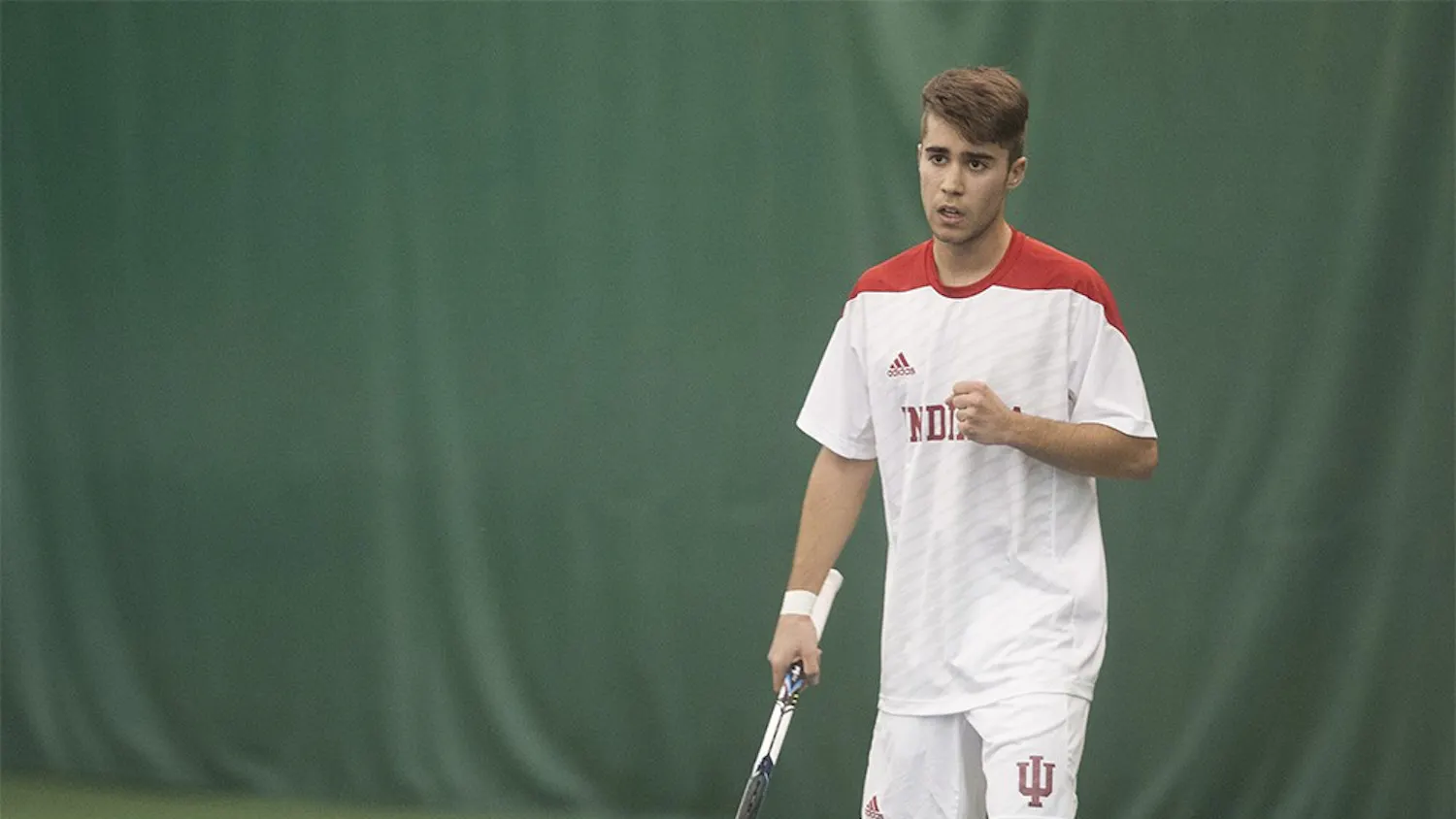 Freshman Antonio Cembellin celebrates after scoring a point against Washington's Sebastian Hawken Jan. 5, at the IU Tennis Center. Cembellin lost 6-3, 1-6, 6-3