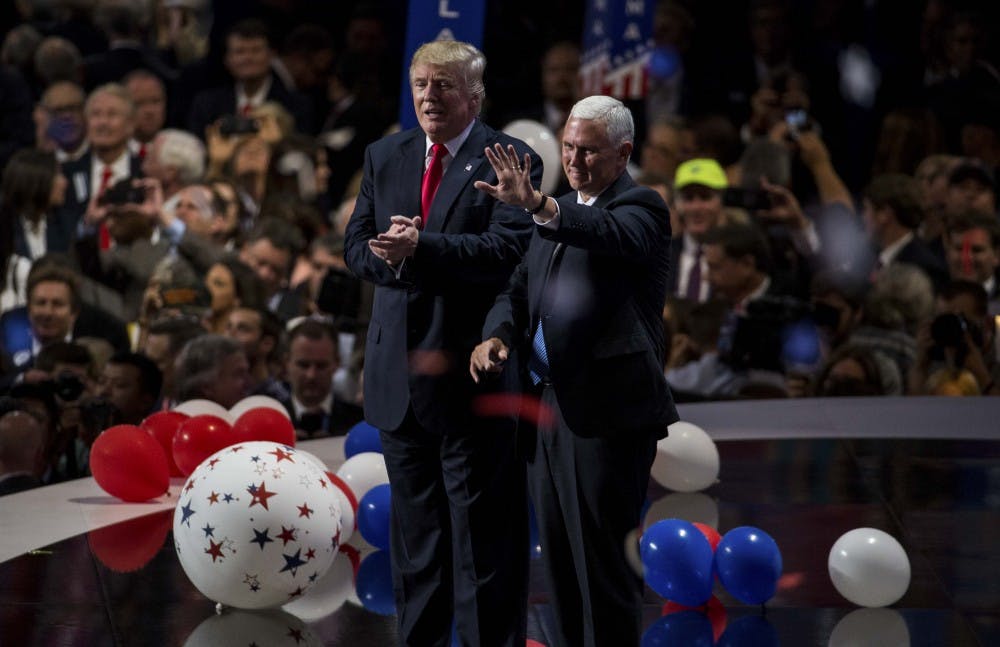 Governor Mike Pence and Republican presidential candidate Donald Trump wave to the audience after Donald Trump's speech accepting the nomination for president at the Republican National Convention in Cleveland, Ohio on Thursday evening at the Quicken Loans Arena.